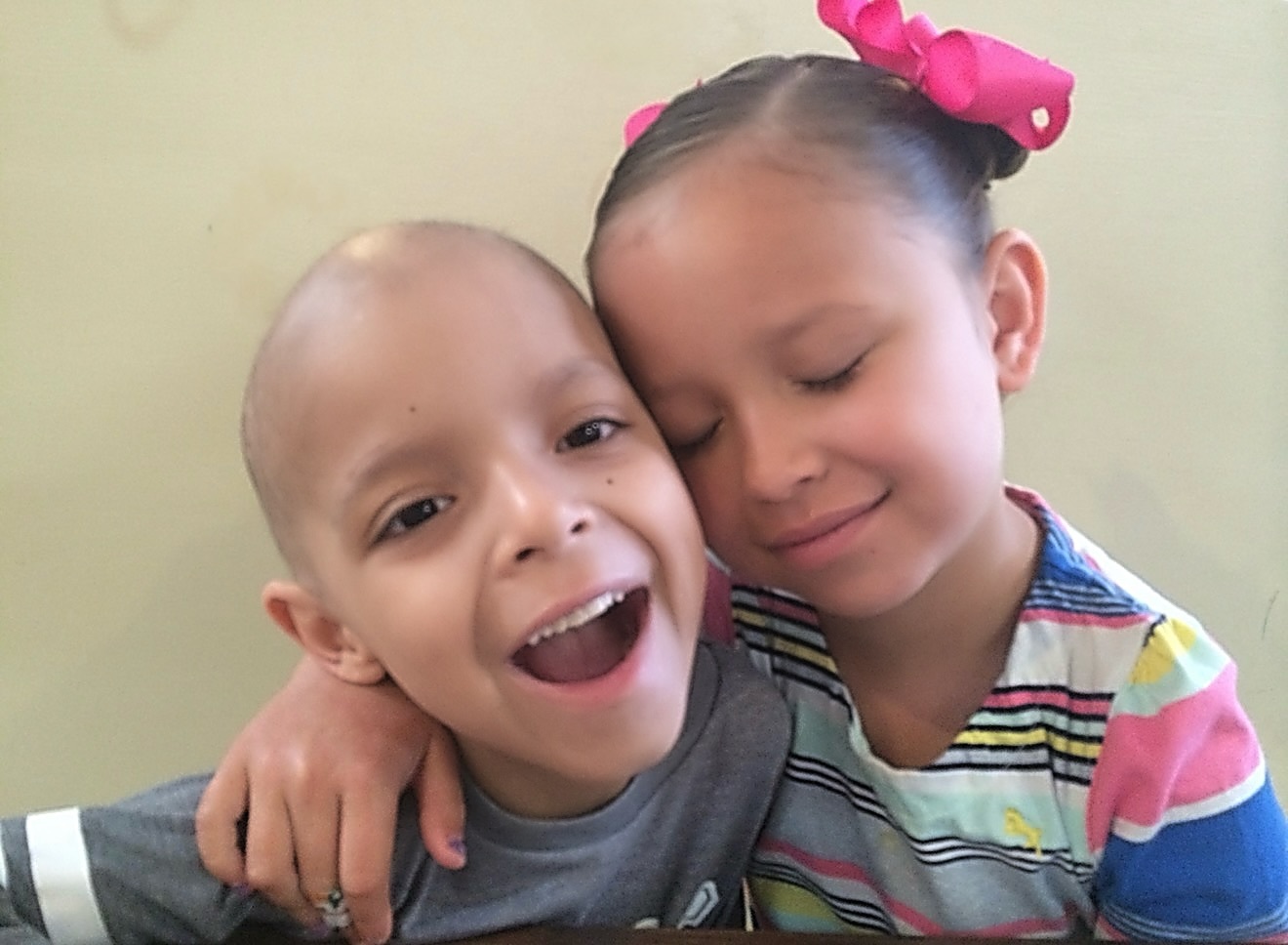 Young Emma embracing Chase as they smile together